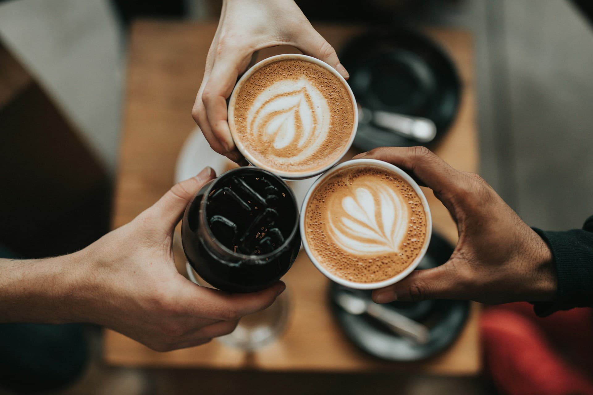 Barista pouring latte art in a specialty coffee shop