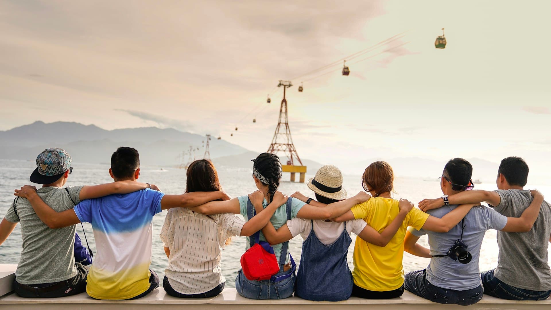 Group of women friends laughing together at a rooftop bar