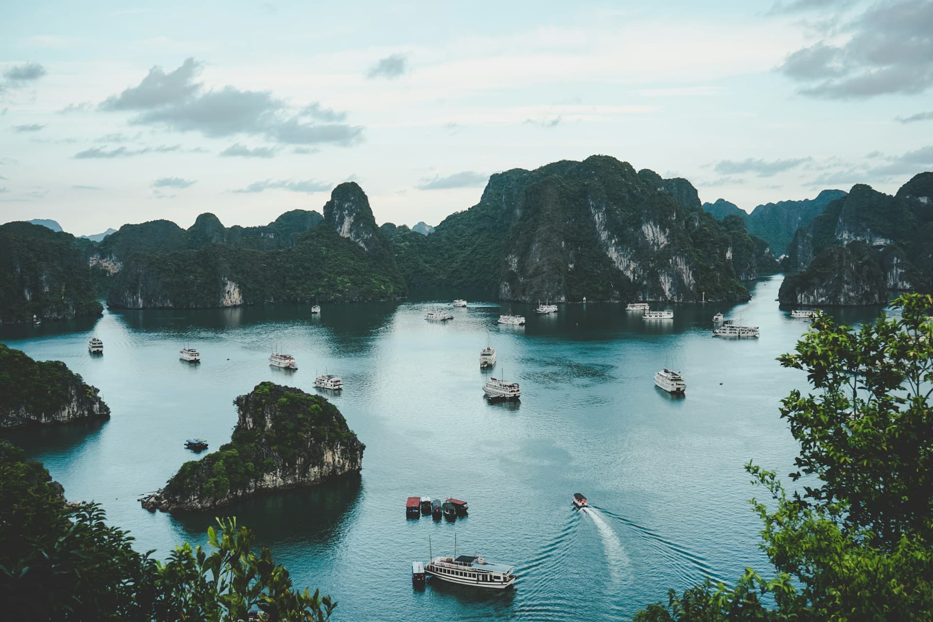 Traditional boats on a river surrounded by limestone karsts in Vietnam